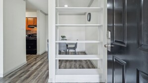 A modern kitchen with dark wood cabinets and a built-in oven.