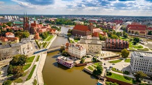 A river flowing through a city with historic buildings and modern architecture.