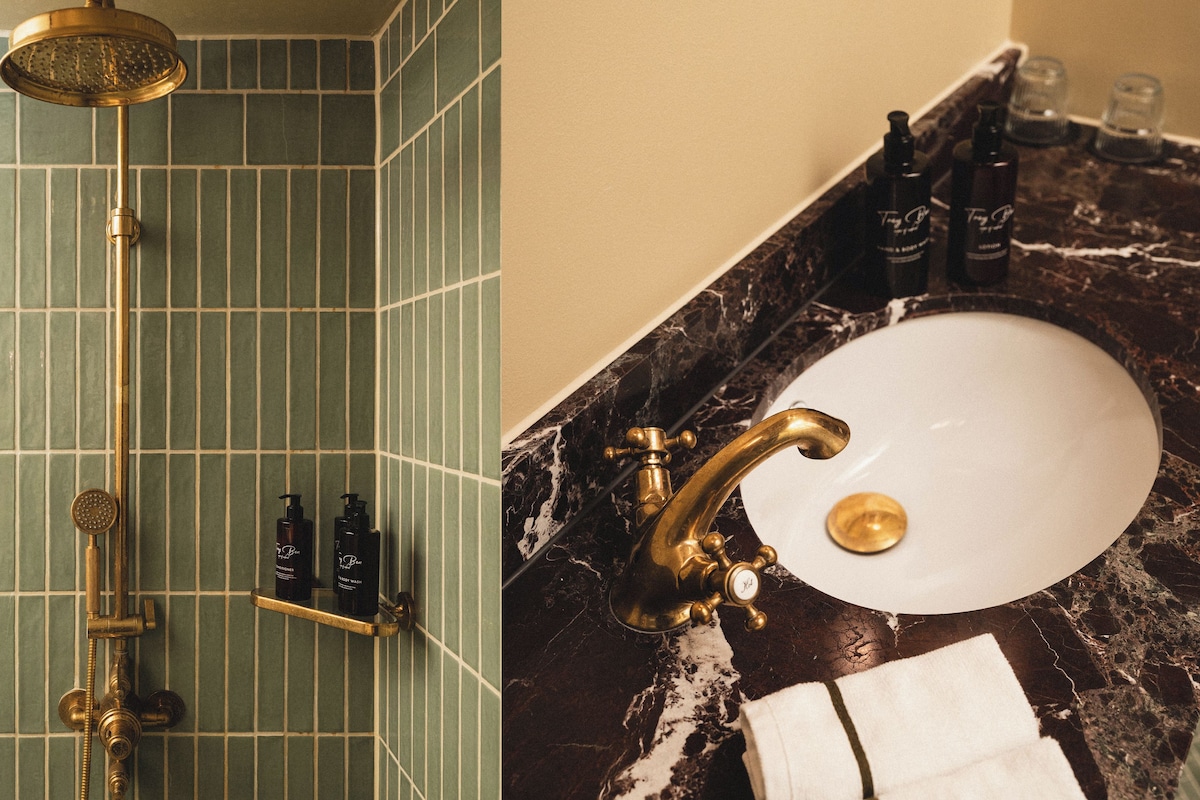 A bathroom with a shower, a sink, and toiletries.