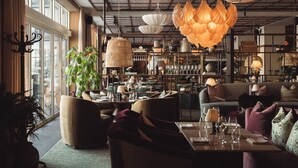 A cozy interior with seating areas, a bar, and a variety of lighting fixtures.