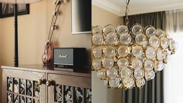 A wooden cabinet with a decorative lamp, a framed picture, and a Marshall speaker.