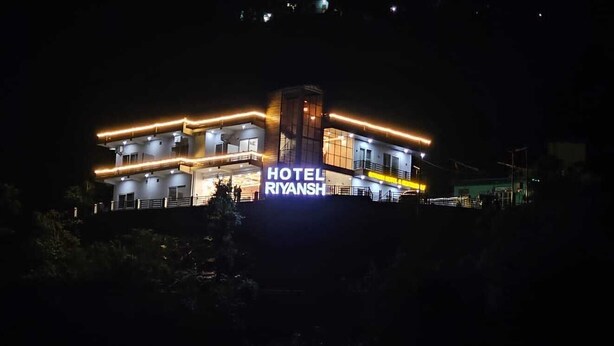 A multi-story building with a prominent "HOTEL RIYANSH" sign, featuring balconies and a modern architectural design. - Hotel Riyansh  (Ukhimath)
