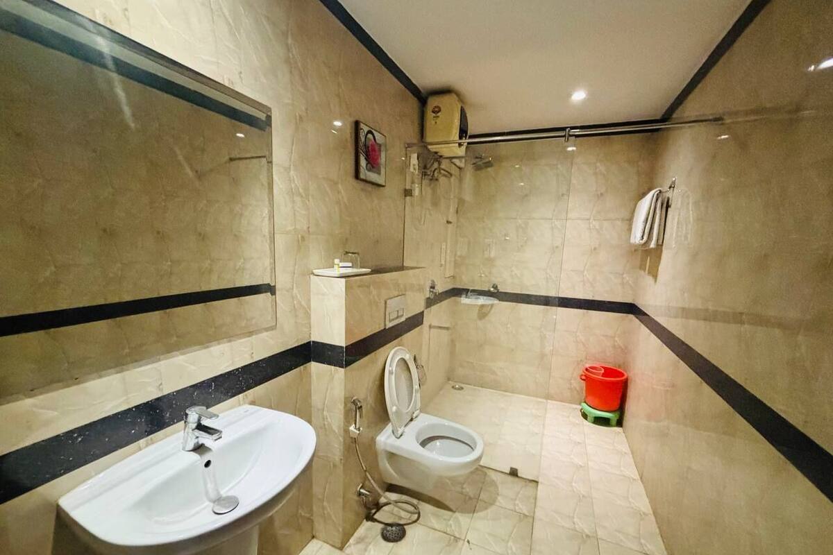 A bathroom with a sink, toilet, and shower.