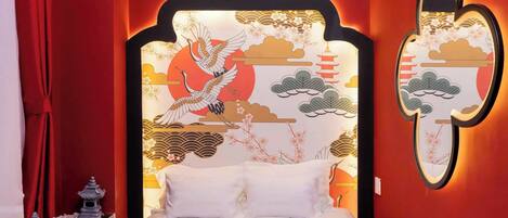 Una cama con cabecera de diseño asiático tradicional, que incluye un pájaro y una pagoda.