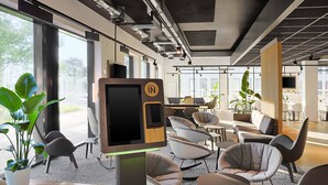 A modern office space with a check-in kiosk, comfortable seating, large windows, and a clean, industrial design. - B&B Hotel Berlin Airport-Nord (Berlin)