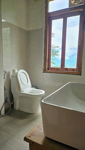 A bathroom with a toilet and a bathtub. - Ruhaani Cottages And Cafe (Banjar)