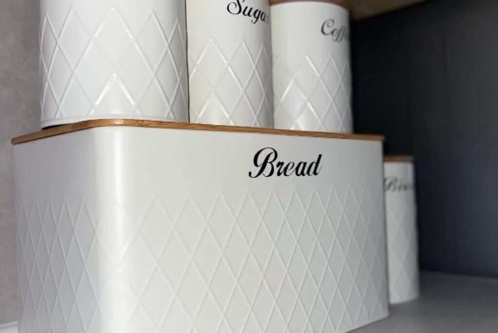 A set of white storage containers with diamond patterns and the word "Bread" on the front.
