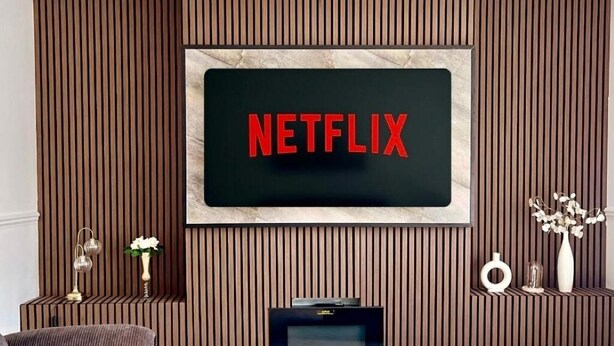 A wall-mounted television with a Netflix logo.