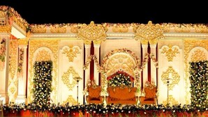 A grand stage with ornate decorations and floral arrangements.