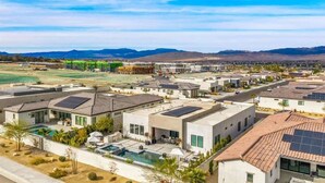 A residential area with modern houses, solar panels, and a swimming pool. - The Desert Oasis Casita (Palm Desert)