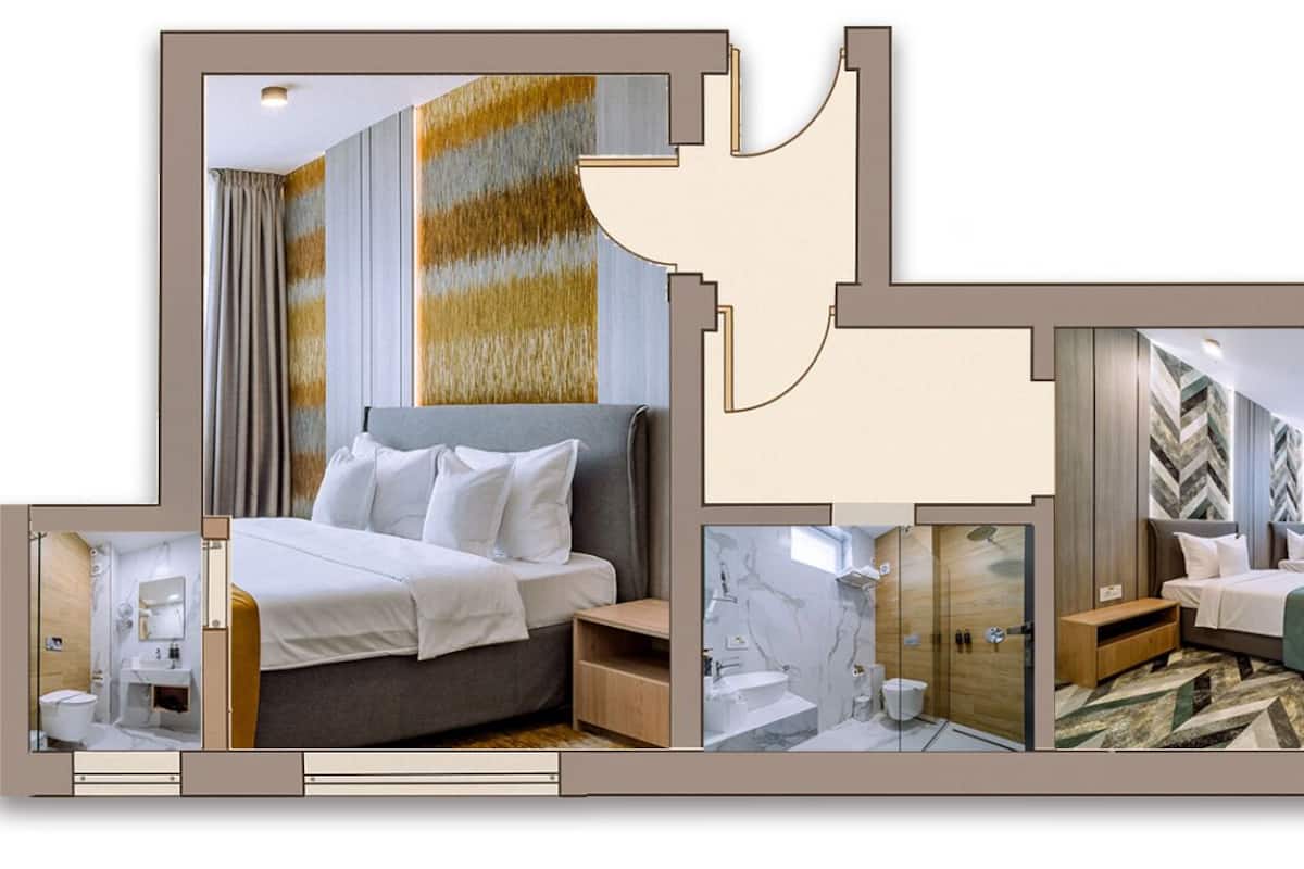 A hotel room with a large bed, a separate bathroom, a seating area, and a TV.