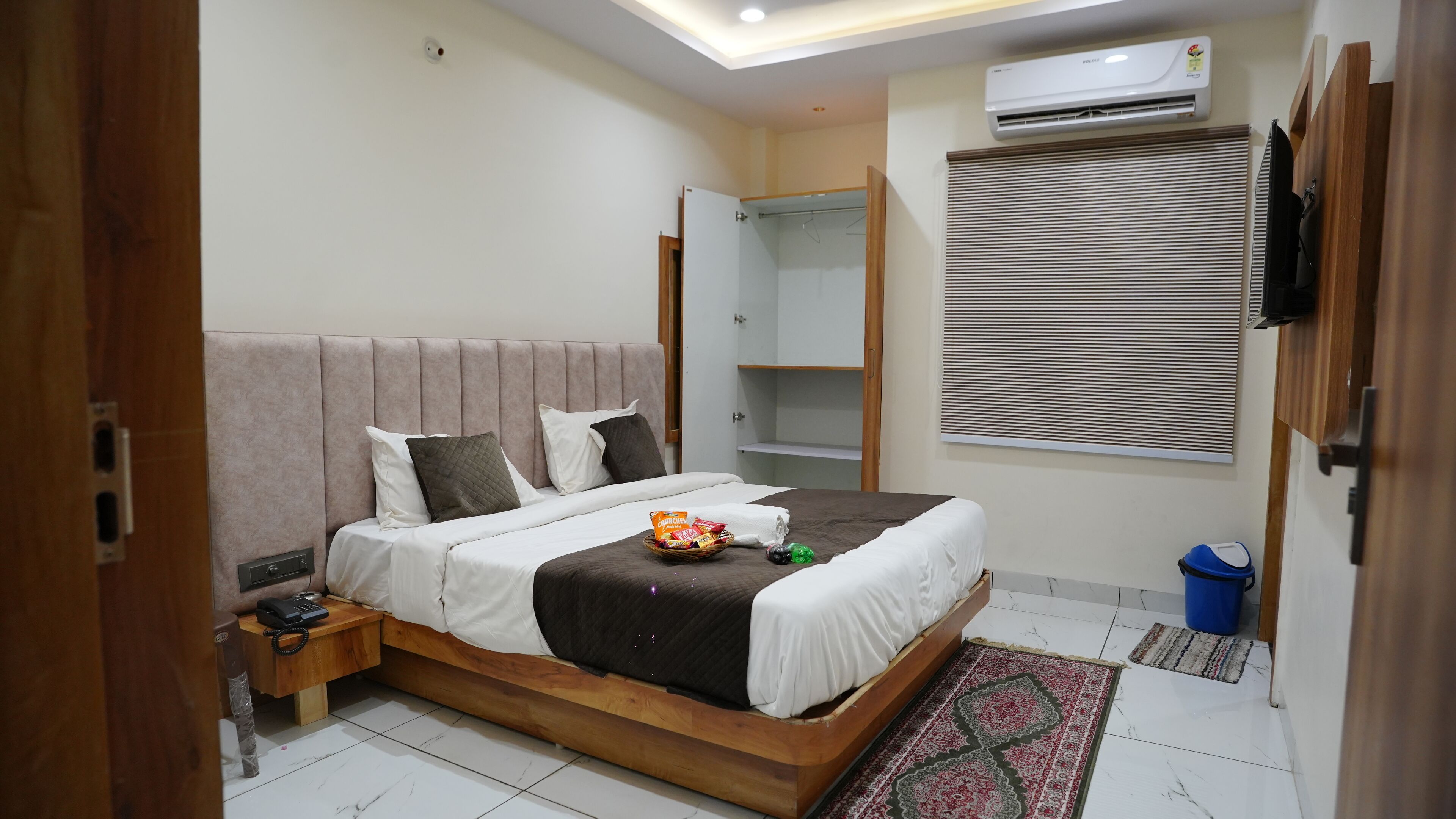 A bedroom with a bed, bedside table, and a wardrobe.