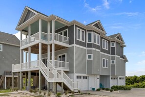 A two-story house with a covered porch and a second-story balcony.