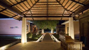 A covered walkway leading to a building with a sign reading "CGI Golf Retreat".