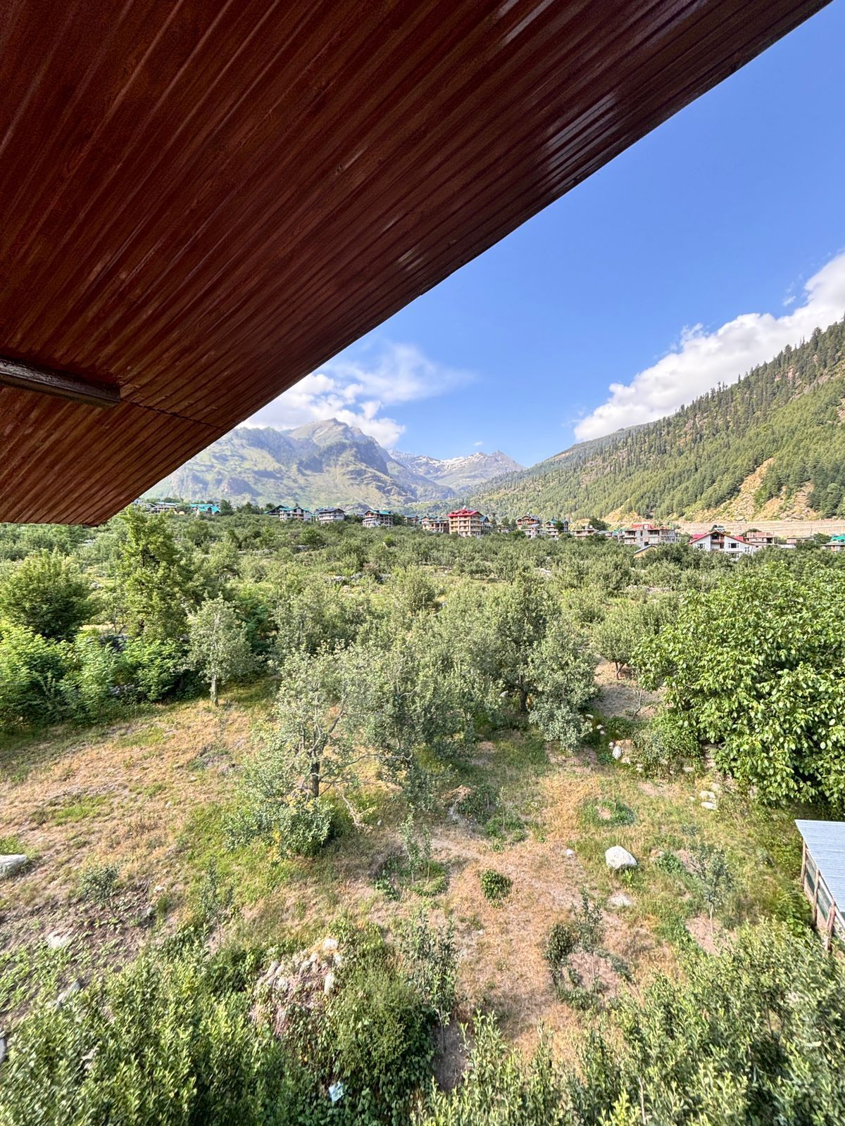A mountainous landscape with a wooden structure overhead.