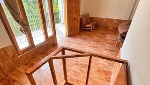A wooden staircase with a handrail leading to a balcony. - Manali Mornings (Manali)