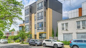 A modern multi-story building with large windows and a mix of brick and metal exterior. - 3 Mi to National Mall: Artsy DC Condo Near Metro! (Washington)