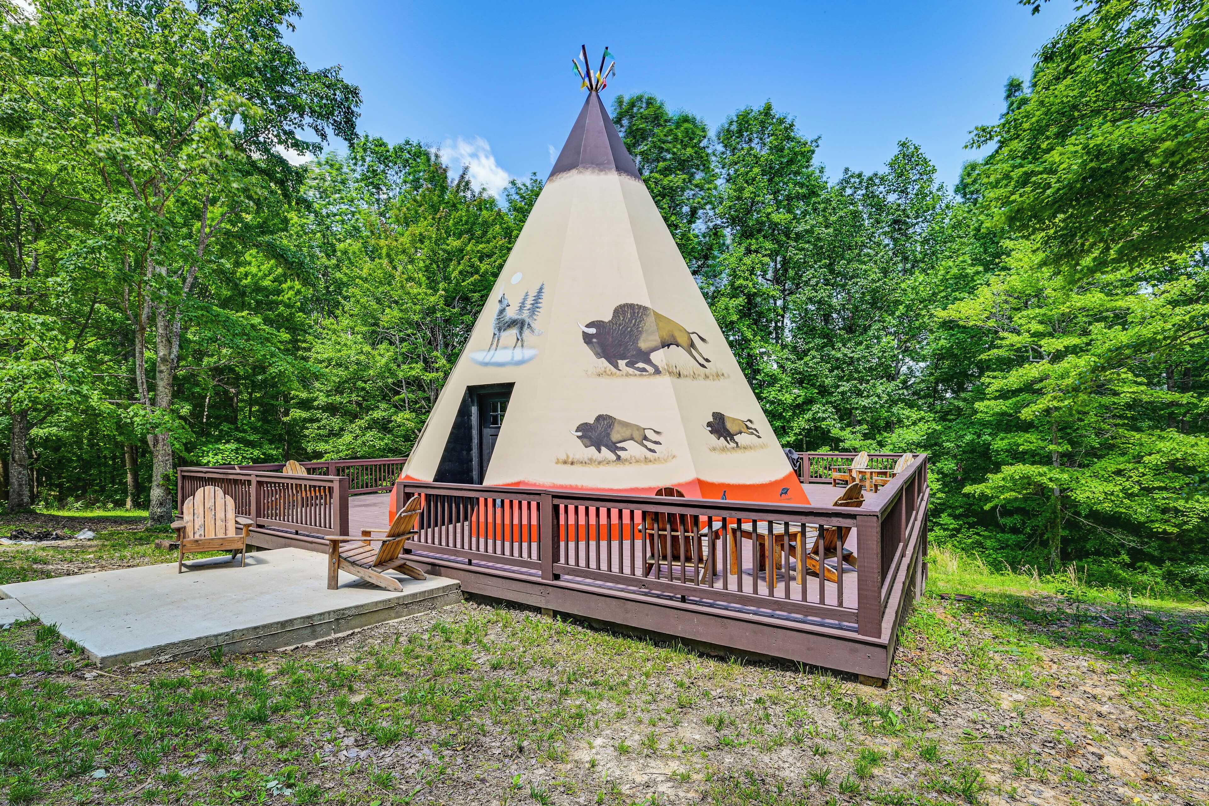 A conical structure with animal depictions, a deck, and seating.