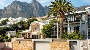 A modern residential area with a prominent mountain in the background. - 2bed Apt 5min Walk From Camps Bay Central Escape (Cape Town)
