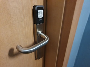 Una puerta con un código QR y un lector de tarjetas.
