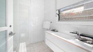 A modern bathroom with a bathtub, a window, and a towel rack. - Oceanic Hideaway 18: 1  BR, 1  BA Apartment in Sorrento, Sleeps 4 (Sorrento)