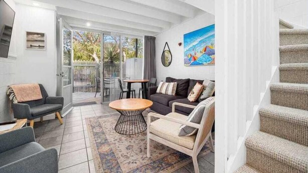 A spacious living area with a sofa set, a coffee table, and a painting on the wall. - Oceanic Hideaway 18: 1  BR, 1  BA Apartment in Sorrento, Sleeps 4 (Sorrento)