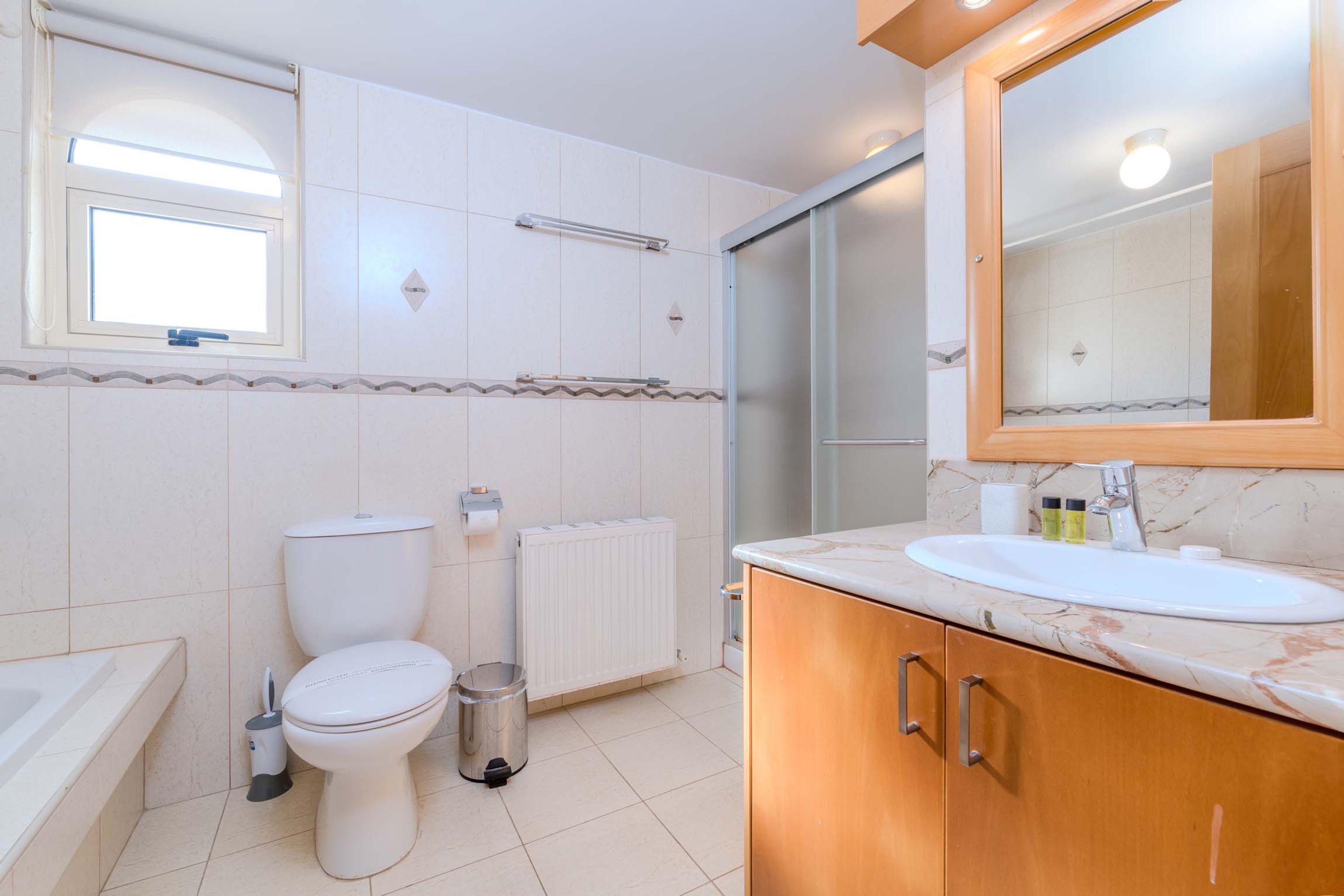 A modern bathroom with a toilet, sink, and shower.