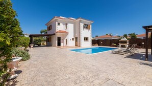 A two-story house with a swimming pool, patio area, and a covered outdoor seating area. - Elena Gardens Villa in Ayia Napa (Sotira)