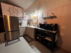 Fridge, microwave, coffee/tea maker, cookware/dishes/utensils