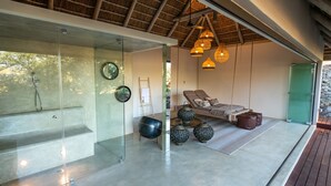 A modern spa area with a glass-enclosed shower, a lounge with a cushioned seating area, and decorative lanterns. - Villa Aloe Vera in Hoedspruit (Hoedspruit)