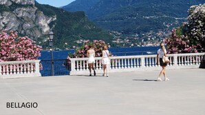 A promenade with a view of a mountainous landscape and a body of water. - COMO - VILLA GABRIELLA - SUNRISE (Capiago Intimiano)