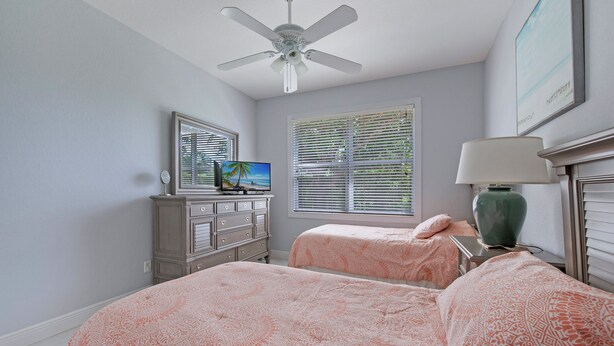 A bedroom with two beds, a ceiling fan, a dresser, a TV, and a window with blinds. - Paradise Retreat! Saltwater Luxury Pool w/Hot Tub (Naples)
