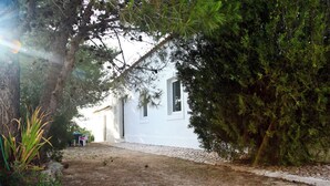 A white building with a gravel pathway leading to a door. - Beautiful property in southern Portugal (Algarve) near Estômbar golf course (Unknown)
