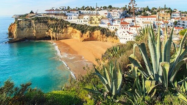 A coastal town with buildings on a cliff overlooking the sea. - Beautiful property in southern Portugal (Algarve) near Estômbar golf course (Unknown)