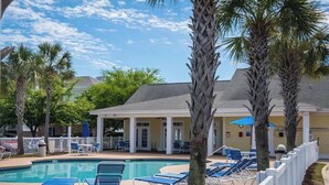 A pool area with lounge chairs and a covered seating area. - Magnificent 2BR condo, ground floor , Pool (Myrtle Beach)