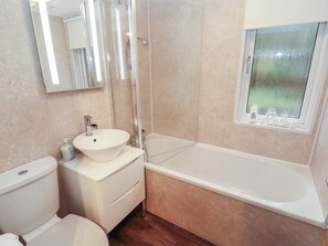 A bathroom with a toilet, sink, shower, and bathtub. - Dovedale Lodge (Windermere)