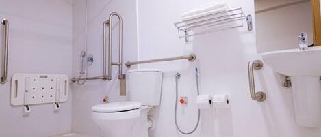 A modern bathroom with a toilet, shower, and sink.