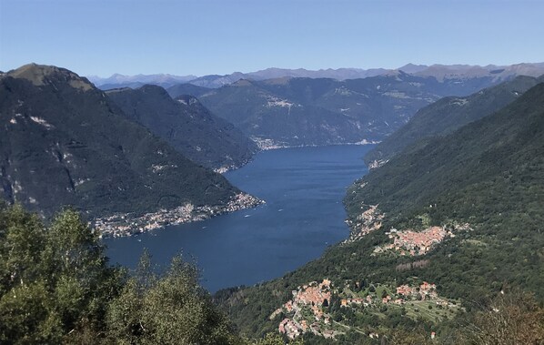 A mountainous landscape with a valley and a lake. - COMO - VILLA GABRIELLA - SUNSET (Capiago Intimiano)