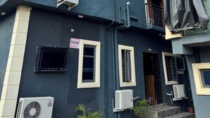 A hotel named Sparcles Hotel & Lounge with a dark facade, multiple windows, and air conditioning units. - Sparcles Hotel and Lounge  (Lagos)