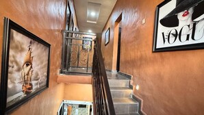A staircase with marble steps and a metal railing, leading to a second floor. - Sparcles Hotel and Lounge  (Lagos)