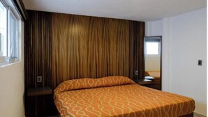 A modern bedroom with a bed, a window, and a mirror. - Hotel El Rincón (San Francisco del Rincón)