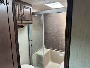 Shower, towels, soap, toilet paper