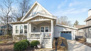 A single-story house with a front porch, a garage, and a well-maintained lawn.