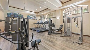 A gym with treadmills, weight machines, and a pull-up bar area. - Saint James Place 218 (Beaver Creek)