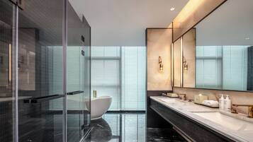 Deluxe Suite, 1 King Bed, Non Smoking | Bathroom | Rainfall showerhead, hair dryer, bathrobes, slippers