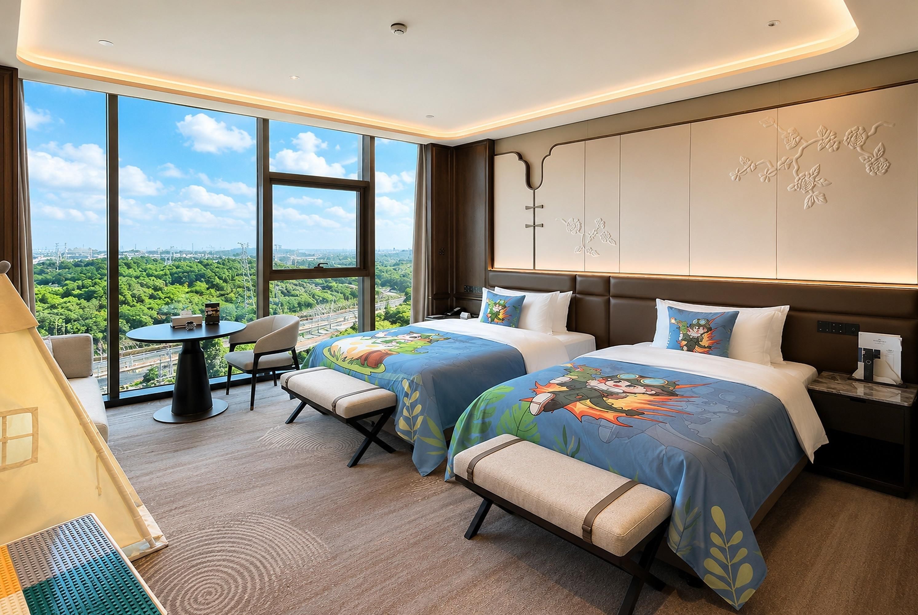 A hotel room with two beds, a small table, a chair, and a view of the city.