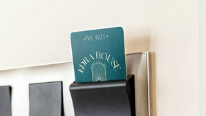 A card reader with a card inserted, labeled 'EDRA HOUSE,' and a wall-mounted panel with three black holders. - EDRA HOUSE  (Cesme)