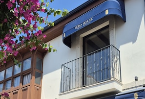 A hotel sign with the name 'EDRA HOUSE HOTEL ALACATI' and a balcony with decorative metal railings. - EDRA HOUSE  (Cesme)
