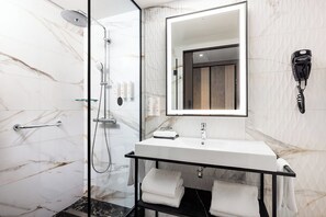 Deluxe Room, 1 King Bed | Bathroom | Shower, hair dryer, towels, soap