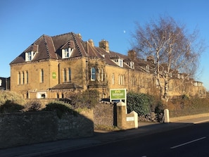 A historic building with a sign indicating it is Eastfield Lodge. - The Den - Small but cosy apartment in the Dales. (Leyburn)